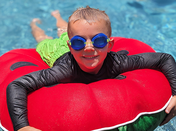 Kid floating on tube in the pool