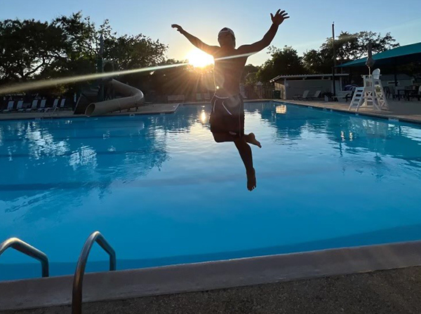 Kid jumping in the pool